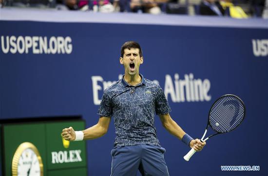 Novak Djokovic of Serbia celebrates scoring during the men's singles final match against Juan Martin del Potro of Argentina at the 2018 US Open tennis tournament in New York, the United States, Sept. 9, 2018. Djokovic claimed the title by defeating Juan Martin del Potro of Argentina with 3-0 in the final. (Xinhua/Wang Ying)