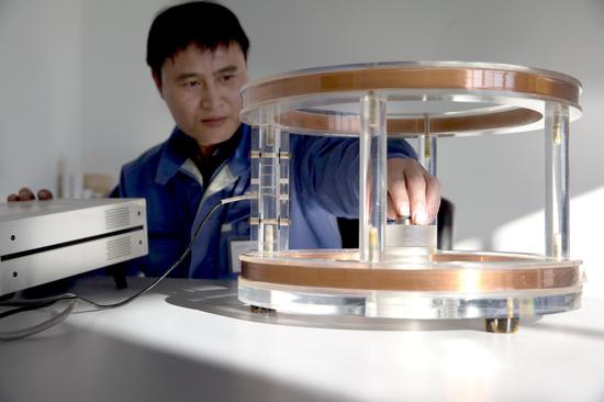 A technician conducts a test at Beijing Zhongke Sanhuan High-Tech Co Ltd. The company's rare-earth products are used in the automobile, household appliance, energy, computer, communication and medical care sectors. (Photo/Xinhua)