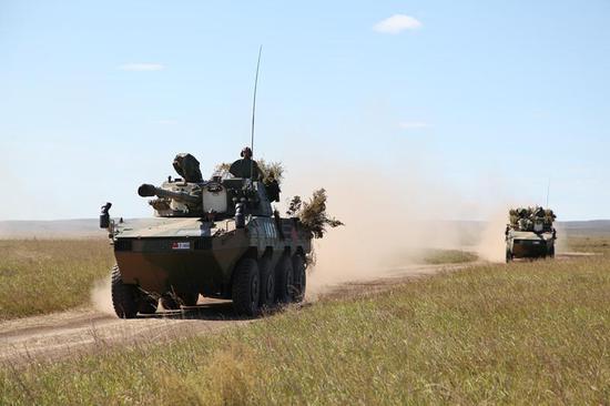 Chinese armed vehicles maneuver at the Tsugol training range in Russia's Trans-Baikal region. About 3200 Chinese troops attended the 
