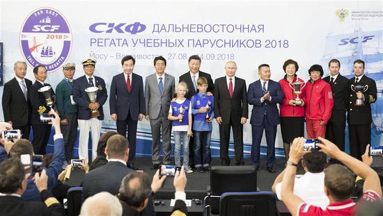 Chinese President Xi Jinping (C, rear) attends an award ceremony for the first race of the SCF Far East Tall Ships Regatta 2018 with Russian President Vladimir Putin, Mongolian President Khaltmaa Battulga, Japanese Prime Minister Shinzo Abe and South Korean Prime Minister Lee Nak-yon after the plenary session of the fourth Eastern Economic Forum (EEF) held in Vladivostok in Russia's Far East, on Sept. 12, 2018. (Xinhua/Huang Jingwen)