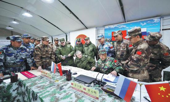 Chinese and Russian commanders discuss strategies during the five-day 