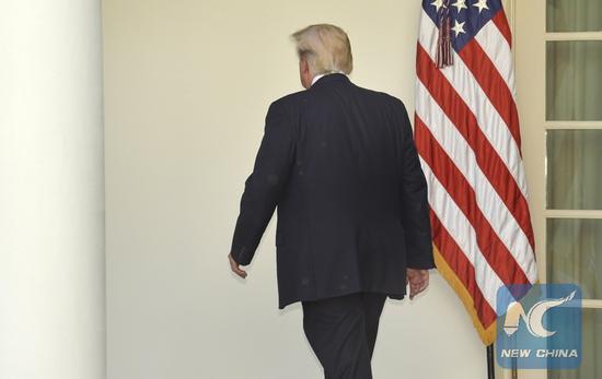 File photo taken on June 1, 2017 shows U.S. President Donald Trump leaves after delivering a speech at the White House in Washington D.C., the United States.  (Xinhua/Mike Theiler)