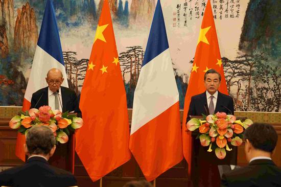 Chinese State Councilor and Foreign Minister Wang Yi (R) and his French counterpart Jean-Yves Le Drian hold a joint press conference in Beijing on September 13, 2018./CGTN Photo