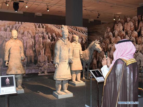 A Saudi visitor takes pictures of the Terra-Cotta Warriors at the exhibition 