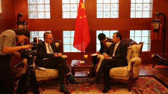 Chinese ambassador to Sweden Gui Congyou (R, F) is seen in an interview. (Photo/CGTN)