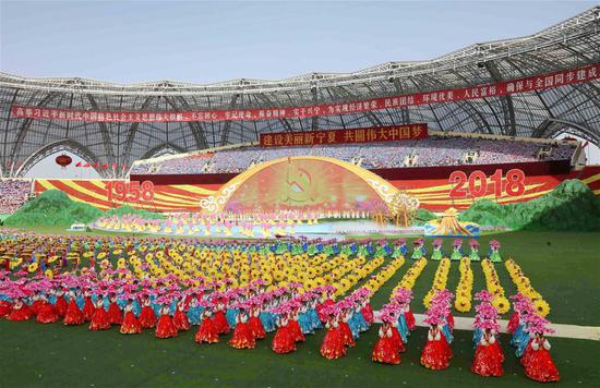 People stage a performance during a grand gathering held to celebrate the 60th anniversary of the founding of Ningxia Hui Autonomous Region at Helan Mountain Stadium in Yinchuan, capital of northwest China's Ningxia Hui Autonomous Region, Sept. 20, 2018. (Xinhua/Liu Weibing)