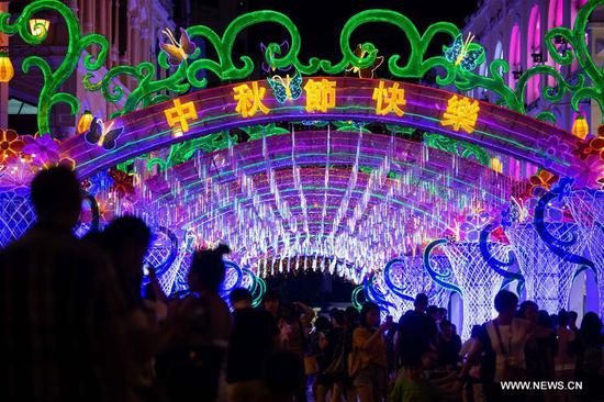 People view the lantern decorations in Macao, south China, Sept. 24, 2018. The Mid-Autumn Festival, which falls on Sept. 24 this year, is a traditional Chinese festival with a custom of family reunion. (Xinhua/Cheong Kam Ka)