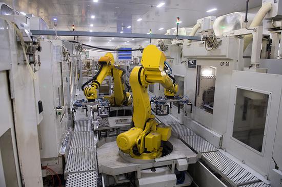 Industrial robots move production material in a factory of Wenzhou Ruiming Industrial Co Ltd in Ruian. (Photo/Xinhua)