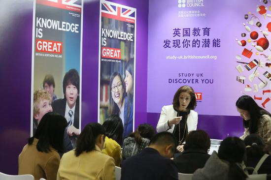 A British Council employee talks about studying in the United Kingdom at an international education fair in Beijing on March 25, 2017. (Photo by A Jing/for China Daily)