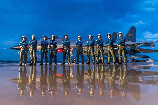 Pilots from an elite fighter jet squadron of the People's Liberation Army Air Force assemble on the tarmac after a training drill. (YANG PAN/FOR CHINA DAILY)