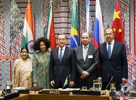 State Councilor and Foreign Minister Wang Yi attends a meeting with the foreign ministers of India, South Africa, Brazil and Russia at the United Nations headquarters in New York on Thursday. (Photo/Xinhua)