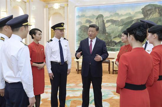 Chinese President Xi Jinping, also general secretary of the Communist Party of China (CPC) Central Committee and chairman of the Central Military Commission, meets with cabin crew of Sichuan Airlines ahead of a reception celebrating the 69th anniversary of the founding of the People's Republic of China, in Beijing, capital of China, Sept. 30, 2018. (Xinhua/Li Xueren)