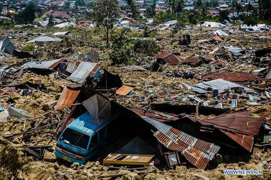 Photo taken on Oct. 2, 2018 shows debris of houses in Balaroa village after earthquake and tsunami in Palu, Central Sulawesi, Indonesia. The death toll of Indonesia's multiple powerful quakes that triggered tsunami in Central Sulawesi province on Friday soared to 1,249 people with 799 others sustaining serious injuries, a governmental disaster official said here on Tuesday. (Xinhua/Iqbal Lubis)