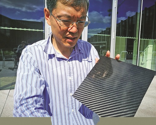 Xiao Ping, a professor of materials science at the NGI, shows a graphene composite. (Photo by ANGUS McNEICE/China Daily)