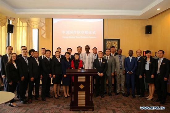 Members of the 19th Chinese medical team in Rwanda pose for a group photo with guests from China and Rwanda at a farewell and welcome reception in Kigali, capital of Rwanda, on Oct. 5, 2018. The 19th Chinese medical team in Rwanda has taken over the role from their predecessors following Friday's farewell and welcome reception in Kigali. (Xinhua/Lyu Tianran)