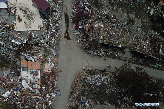 Photo taken on Oct. 8, 2018 shows the aerial view of the debris after the earthquake and tsunami in Palu, Central Sulawesi, Indonesia. Death toll from multiple powerful quakes and an ensuing tsunami striking Central Sulawesi province of Indonesia on September 28 jumped to 1,948 on Monday and more than 5,000 others went missing, according to a disaster agency official here. (Xinhua/Wang Shen)