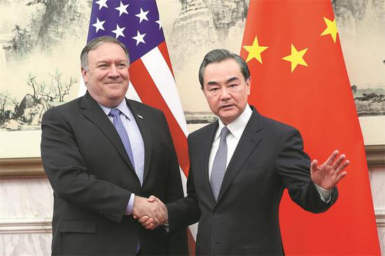 State Councilor and Foreign Minister Wang Yi greets U.S. Secretary of State Mike Pompeo at the Diaoyutai State Guesthouse in Beijing on Monday. Wang said any new negotiations must be based on equality, integrity and seriousness. (Photo/CHINA DAILY)