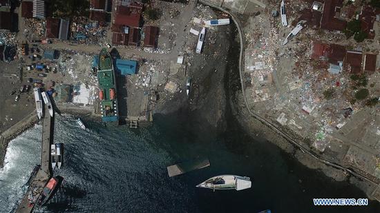 Aerial photo taken on Oct. 10, 2018 shows a washed up steamship in Donggala, Central Sulawesi, Indonesia. The Indonesian national disaster agency put the death toll from multiple strong quakes and an ensuing tsunami in Central Sulawesi province at 2,045 on Wednesday, a day before the search operation ended. (Xinhua/Wang Shen)