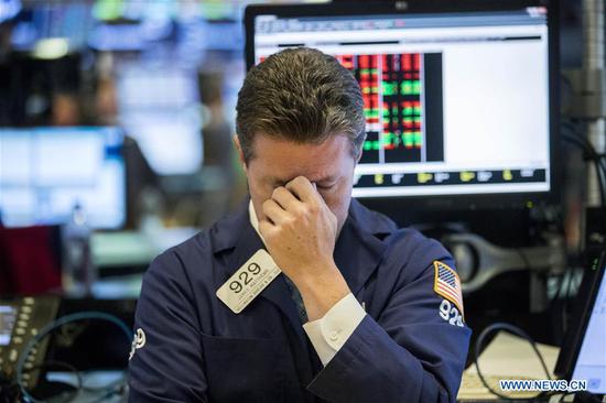 A trader reacts at the New York Stock Exchange in New York, the United States, on Oct. 11, 2018. U.S. stocks extended deep losses in volatile trading on Thursday. (Xinhua/Wang Ying)