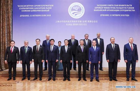 A family photo of leaders attending the 17th meeting of the Shanghai Cooperation Organization (SCO) Council of Heads of Government in Dushanbe, Tajikistan, October 12, 2018. (Xinhua Photo)