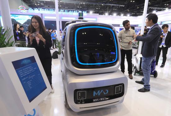 A self-driving delivery vehicle on display at the World Intelligent Connected Vehicles Conference in Beijing. (Photo by Cheng Gong / for China Daily)