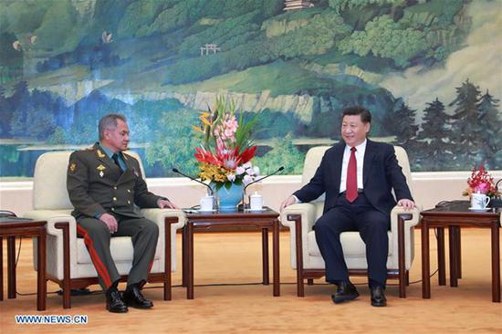 Chinese President Xi Jinping (R) meets with visiting Russian Defense Minister Sergei Shoigu at the Great Hall of the People in Beijing, capital of China, Oct. 19, 2018. (Xinhua/Li Gang)