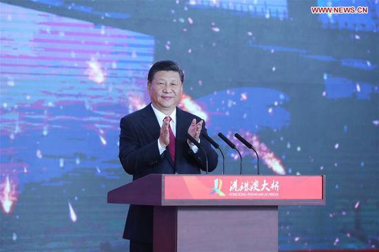 Chinese President Xi Jinping, also general secretary of the Communist Party of China Central Committee and chairman of the Central Military Commission, announces the opening of the Hong Kong-Zhuhai-Macao Bridge at an opening ceremony in Zhuhai, south China's Guangdong Province, Oct. 23, 2018. (Xinhua/Ju Peng)