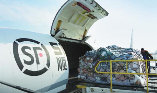 Goods are loaded onto an airplane of SF Airlines. (Photo/China Daily)