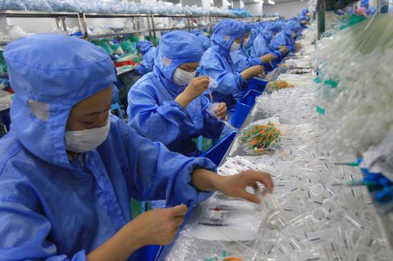 Workers assemble medical equipment in a manufacturing company in Wenzhou, Zhejiang province. (Photo provided to China Daily)