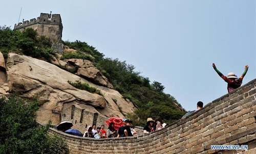 Tourists climb the Badaling section of the Great Wall as they stay in the sweltering weather in Beijing, capital of China, Aug. 5, 2018. (Xinhua/Chen Xiaodong)