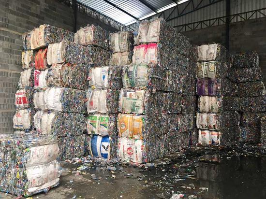 Plastic is crushed into bales for recycling. (CGTN Photo)