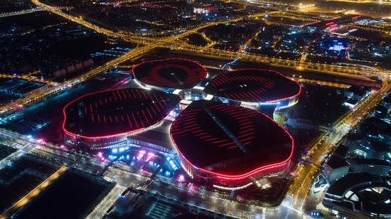 Aerial photo taken on Oct. 21, 2018 shows a night view of the National Exhibition and Convention Center (Shanghai), the main venue to hold the upcoming first China International Import Expo (CIIE), in Shanghai, east China. (Xinhua/Ding Ting)