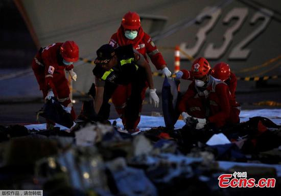 Rescue workers of the crashed Lion Air flight JT610 sort out newly recovered debris at Tanjung Priok port in Jakarta, Indonesia, Oct. 30, 2018. The search continued Tuesday for bodies and the 