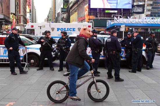 Police officers stand guard at Times Square in New York, the United States, on Oct. 31, 2018. New York City stepped up security for the annual Halloween parade on Wednesday, a year after the holiday was scarred by a terror truck attack which claimed eight lives and injured a dozen in lower Manhattan. (Xinhua/Li Rui)