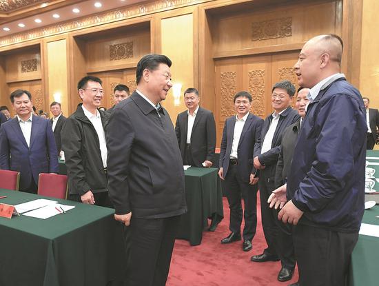 President Xi Jinping greets entrepreneurs, mostly from small and medium-sized companies, at a symposium in the Great Hall of the People in Beijing on Thursday. (Photo/Xinhua)