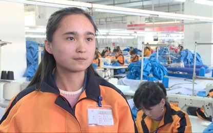 Humagu Abubu, 19, who was going to marry a man she had never met by family arrangement, now works at a clothing factory after she graduated from a center in Kashgar. /CGTN Photo 