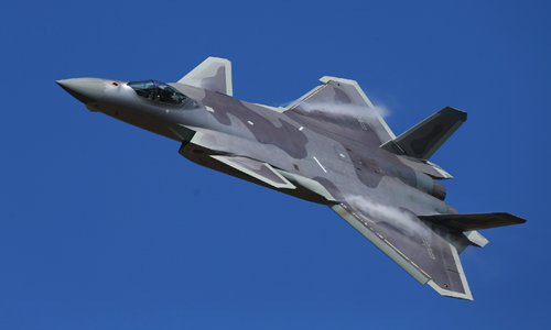 China's J-20 stealth fighter jet displays its new coating of stealth material and flies over the exhibition hall at Airshow China 2018 on Tuesday. (Photo: Cui Meng/GT)