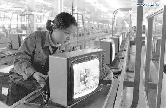Undated photo shows a worker checking a television set in Shanghai, east China. Shanghai No. 1 television factory in February 1982 put into pilot production of color TV with the assembling equipment imported from Japan. (Xinhua/Yang Putao)
