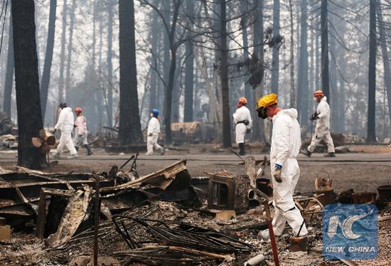 Rescuers work among debris after the wildfire in Paradise, California, the United States, on Nov. 13, 2018. (Xinhua/Li Ying)