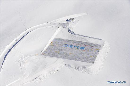 A gigantic postcard is seen on the Aletsch glacier under Jungfraujoch in Switzerland, on Nov. 16, 2018. The gigantic postcard breaking the Guinness World Records was staged just under the Swiss Jungfraujoch on Friday to raise awareness worldwide of the emergency and necessity to fight climate change. (Xinhua/Xu Jinquan)