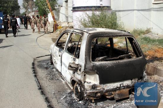 A burned out vehicle is seen at the attack site in Karachi, Pakistan, on Nov. 23, 2018. At least five people including two policemen were killed on Friday morning in a terrorist attack in the diplomatic area in Karachi, police and hospital officials said. (Xinhua/Stringer)