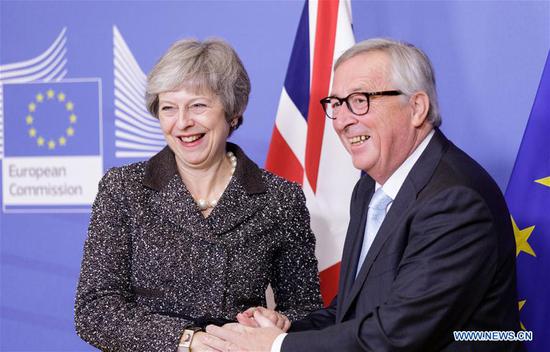 British Prime Minister Theresa May (L) shakes hands with European Commission President Jean-Claude Juncker during their meeting to discuss Brexit at the EU headquarters in Brussels, Belgium, on Dec. 11, 2018. Theresa May launched her mission Tuesday to attempt to rescue her Brexit deal with a round of meetings with European Union (EU) member leaders. (Xinhua)