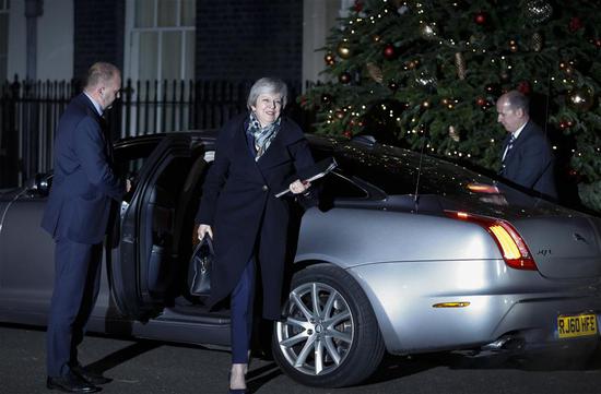 British Prime Minister Theresa May (C) returns to 10 Downing Street after a confidence vote in London, Britain, on Dec. 12, 2018. Theresa May on Wednesday won by a large margin a confidence vote by her fellow Conservative members of parliament. (Xinhua/Han Yan)