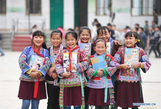 Photo taken on Nov. 29, 2017 shows girls posing for photo at a school in Baiyun Township in Rongshui Miao Autonomous County, south China's Guangxi Zhuang Autonomous Region. (Xinhua/Huang Xiaobang)