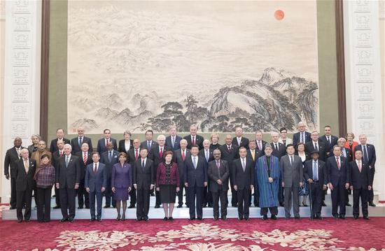 Chinese President Xi Jinping (C, front row) poses for a group photo with foreign delegates attending the just concluded 2018 Imperial Springs International Forum held in Guangzhou, ahead of a meeting with them at the Great Hall of the People in Beijing, capital of China, Dec. 12, 2018. (Xinhua/Wang Ye)