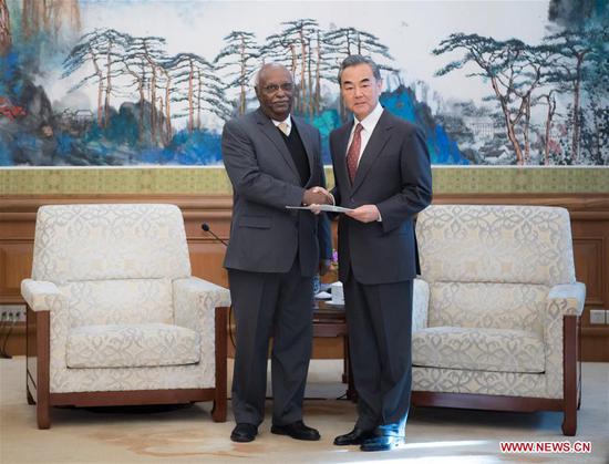 Chinese State Councilor and Foreign Minister Wang Yi (R) meets with Rahamtalla Mohamed Osman Elnor, first African Union (AU) representative to China, in Beijing, capital of China, Dec. 13, 2018. Osman submitted his letter of appointment to Wang Yi here on Thursday. (Xinhua/Zhai Jianlan)