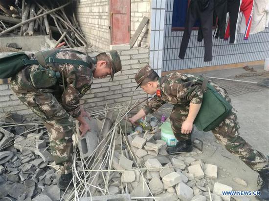 Rescuers work at quake-hit Longdong Village of Xingwen County in Yibin, southwest China's Sichuan Province, on Dec. 16, 2018.  (Xinhua/Zheng Lei)