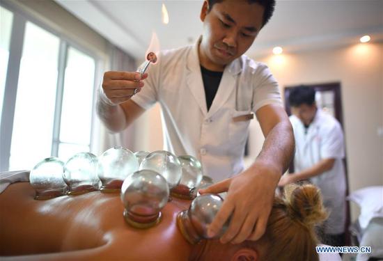 A Russian tourist receives cupping treatment at a sanatorium in Sanya, south China's Hainan Province, June 2, 2018. (Xinhua/Guo Cheng)