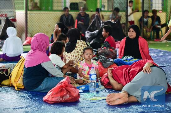 Photo taken on Dec. 25, 2018 shows tsunami survivors rest at a temporary shelter in Labuan of Pandeglang in Banten Province, Indonesia. (Xinhua/Du Yu)