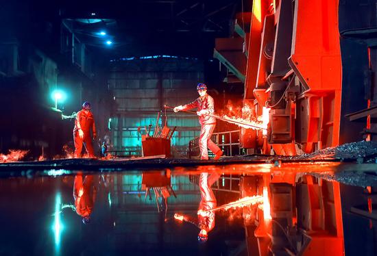 Employees perform smelting operations at a steel plant in Maanshan, Anhui province. [Photo by Zhang Mingwei/For China Daily]